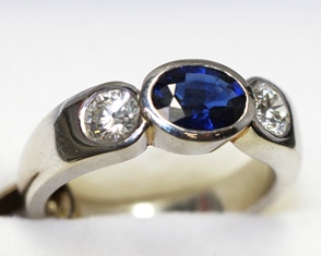 Sapphire and diamond three stone platinum ring